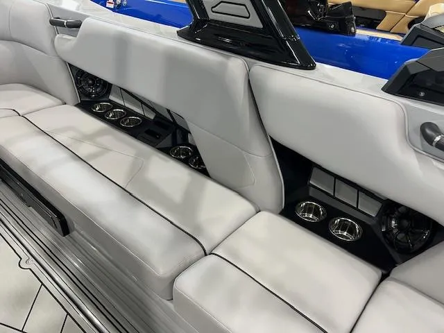 Slide: The Image of 2025 Moomba Tykon boat interior with sleek gray seating and built-in cup holders. - 11