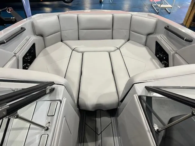 Slide: The Image of 2025 Moomba Tykon boat interior with gray cushioned seating and sleek design. - 6