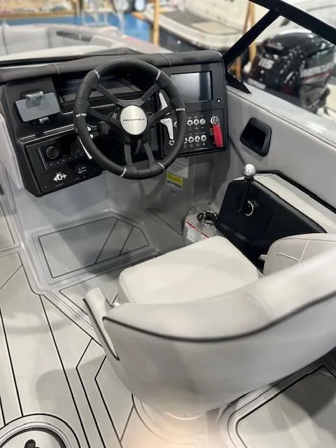Slide: The Image of 2025 Moomba Tykon boat interior with steering wheel and control panel. - 7