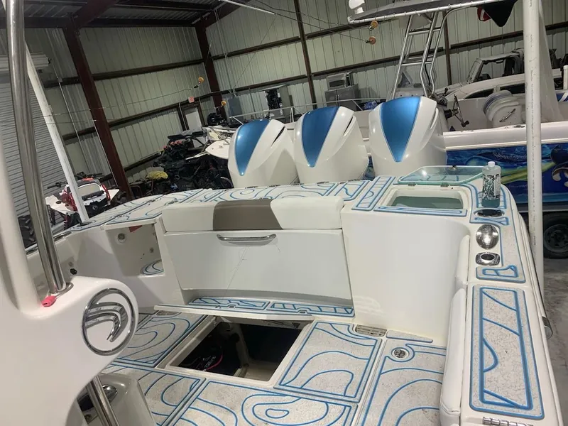 Slide: The Image of 2016 Edgewater 368 CC boat interior with triple outboard engines in storage. - 11