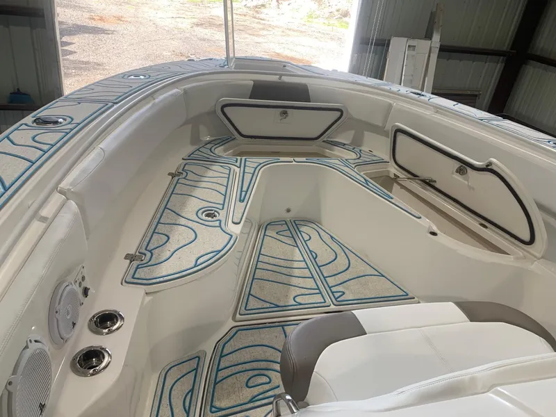 Slide: The Image of 2016 Edgewater 368 CC boat interior with patterned flooring and storage compartments. - 17