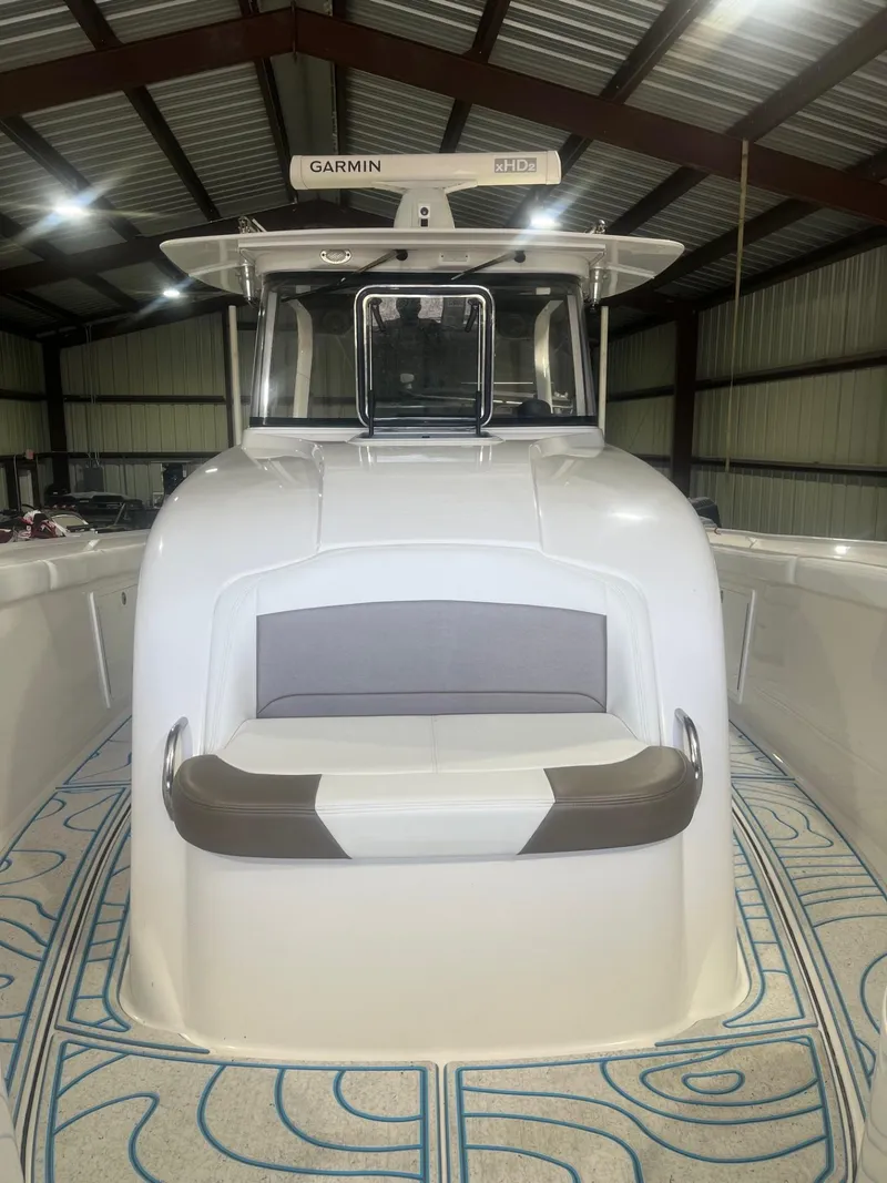 Slide: The Image of 2016 Edgewater 368 CC boat in a warehouse, featuring Garmin equipment. - 19