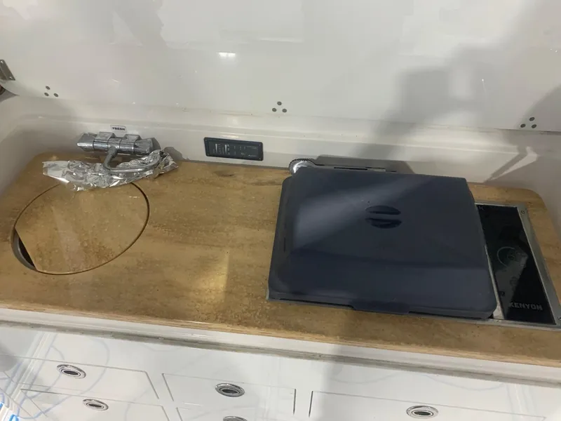 Slide: The Image of 2016 Edgewater 368 CC boat kitchen with sink and stove. - 20