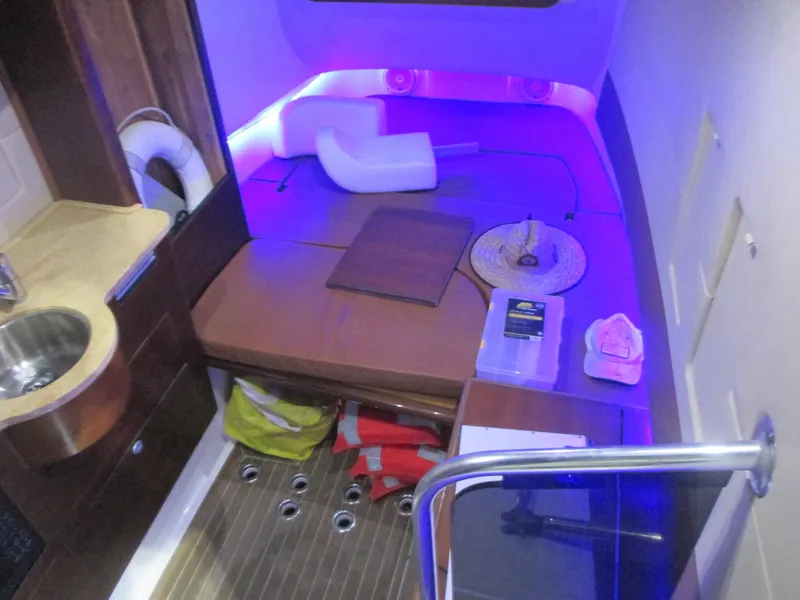 Slide: The Image of Interior cabin of 2016 Edgewater 368 CC boat with seating and ambient lighting. - 21