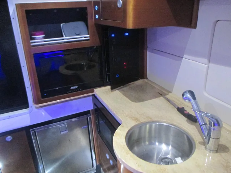 Slide: The Image of 2016 Edgewater 368 CC boat interior with sink, countertop, and storage cabinets. - 22