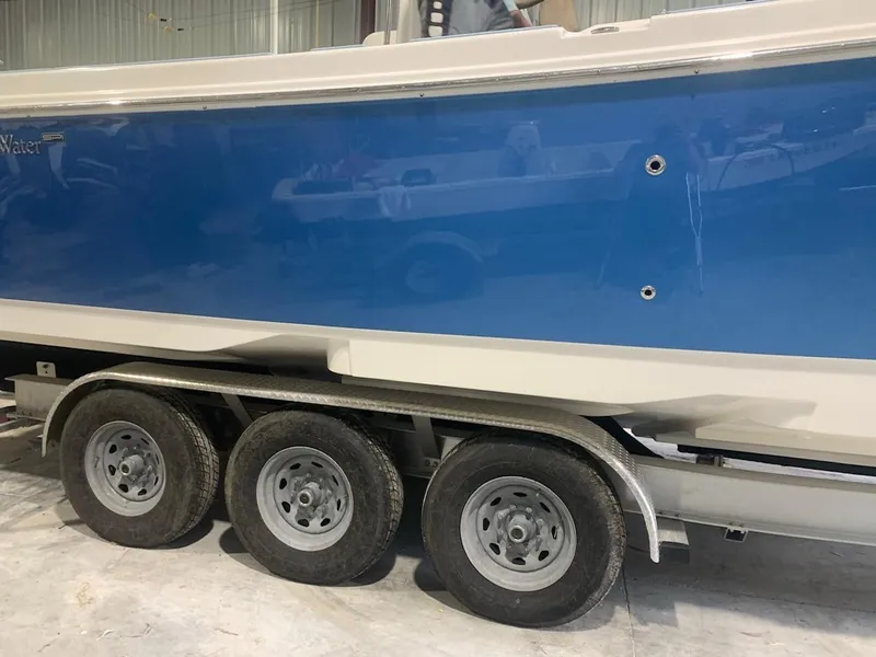 Slide: The Image of 2016 Edgewater 368 CC boat on a triple-axle trailer in a garage. - 4