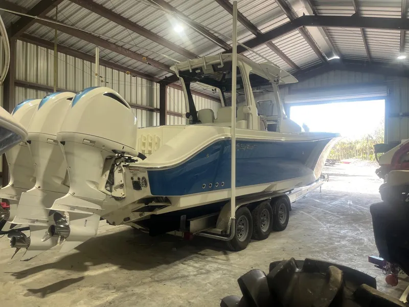 Slide: The Image of 2016 Edgewater 368 CC boat with triple engines in a storage facility. - 6