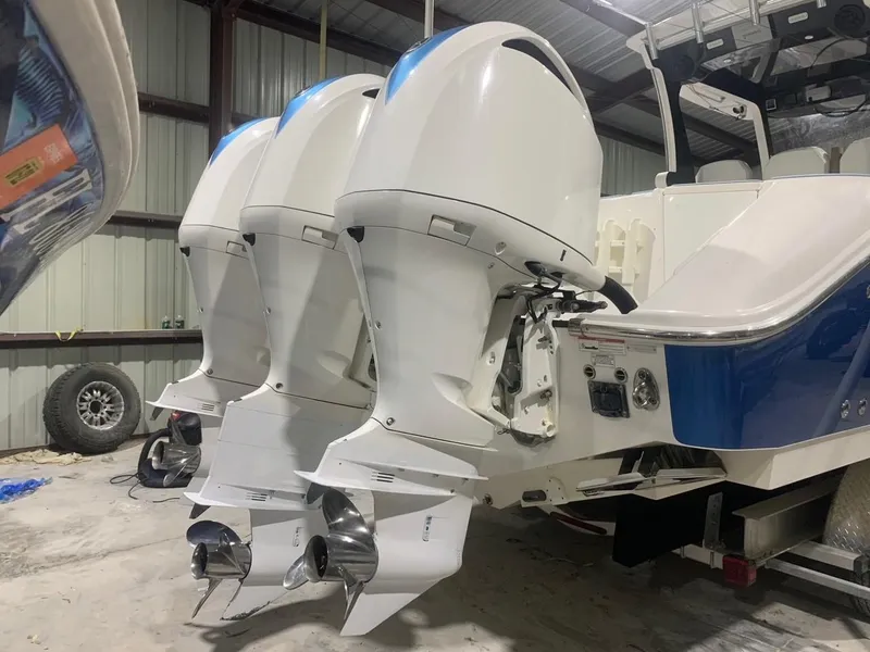 Slide: The Image of 2016 Edgewater 368 CC boat with triple outboard engines in a storage facility. - 7