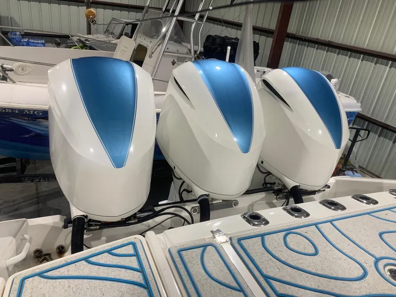 Slide: The Image of Three powerful outboard motors on a 2016 Edgewater 368 CC boat in a storage facility. - 8