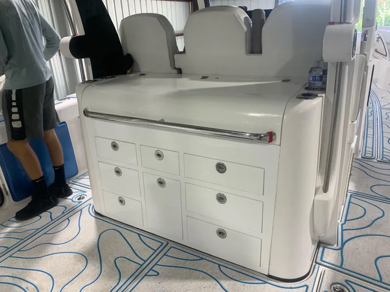 Slide: The Image of 2016 Edgewater 368 CC boat interior with storage drawers and seating. - 9