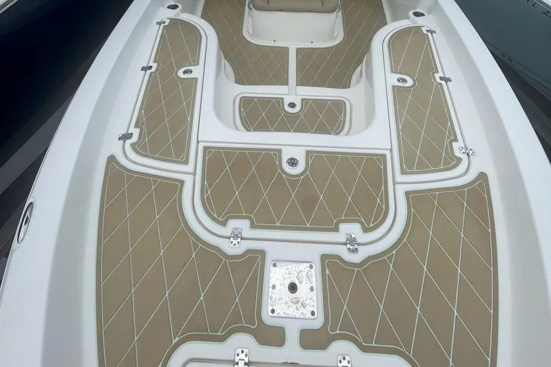 Slide: The Image of 2018 NauticStar 265 XTS boat deck with tan diamond-patterned flooring. - 7