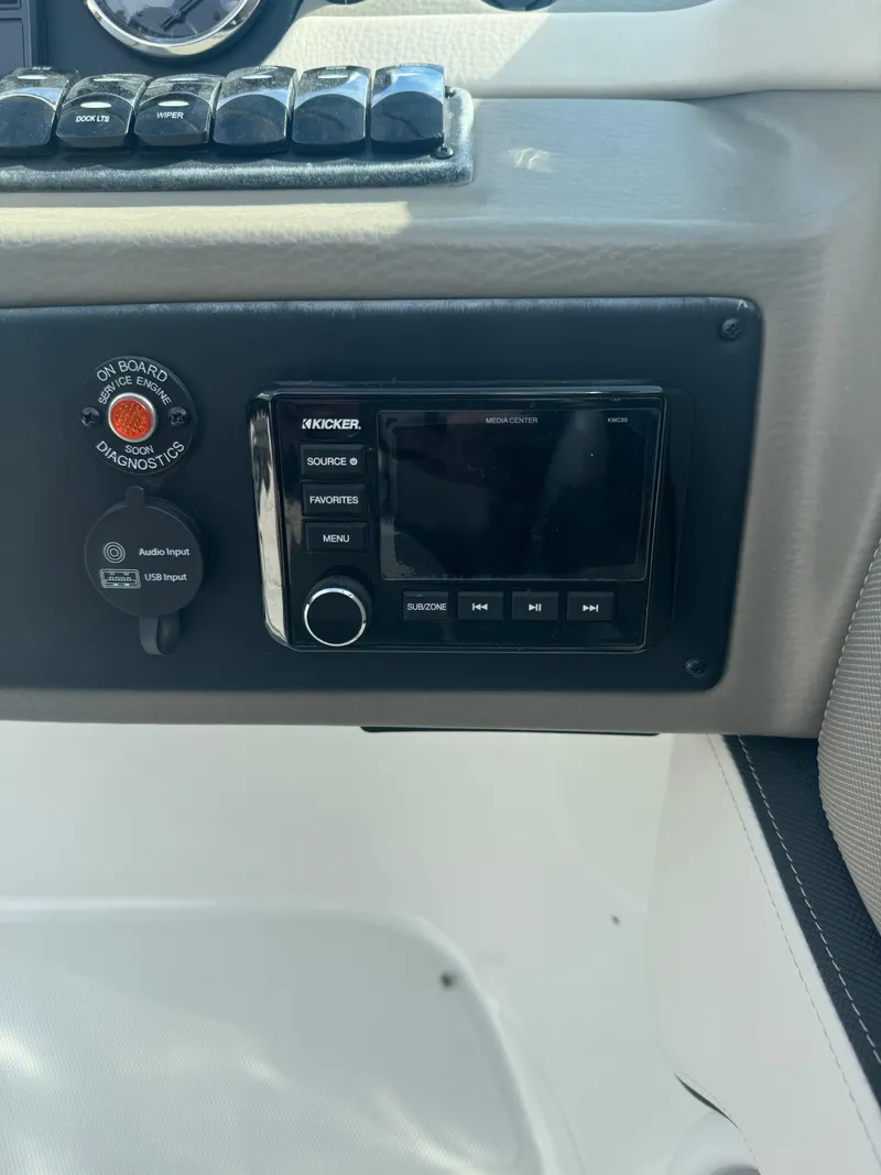 Slide: The Image of 2020 Crownline 255 SS boat dashboard with control panel and audio system. - 11