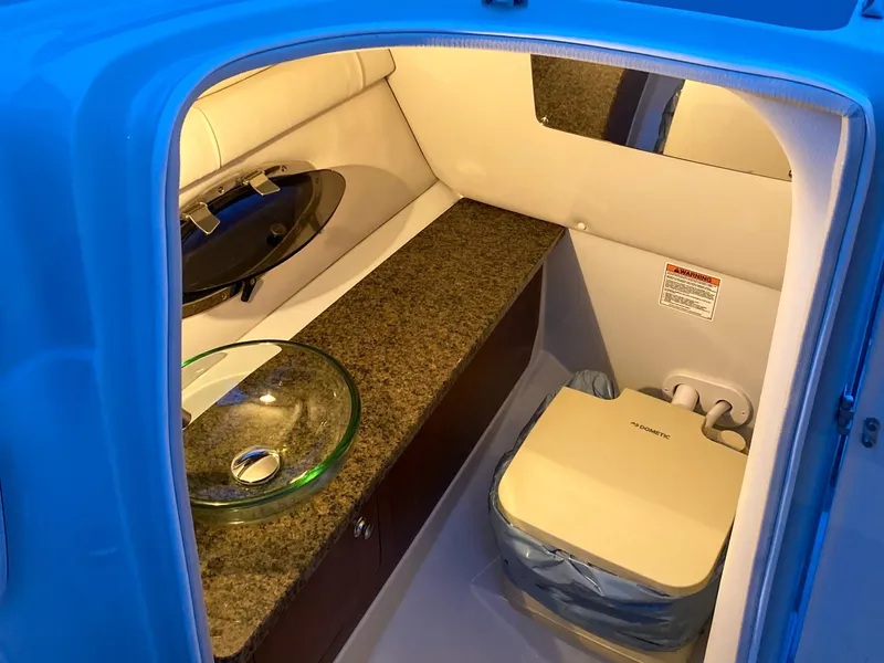 Slide: The Image of 2020 Crownline 255 SS boat interior with granite countertop and modern sink. - 12
