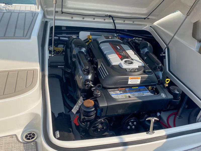 Slide: The Image of 2020 Crownline 255 SS boat engine compartment, showcasing a powerful inboard motor. - 14