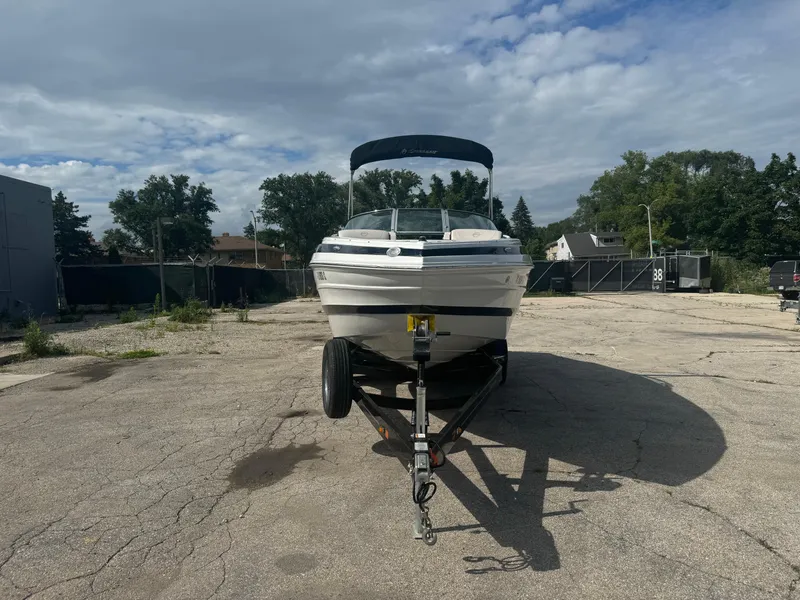 Slide: The Image of 2020 Crownline 255 SS boat on trailer in outdoor setting. - 17