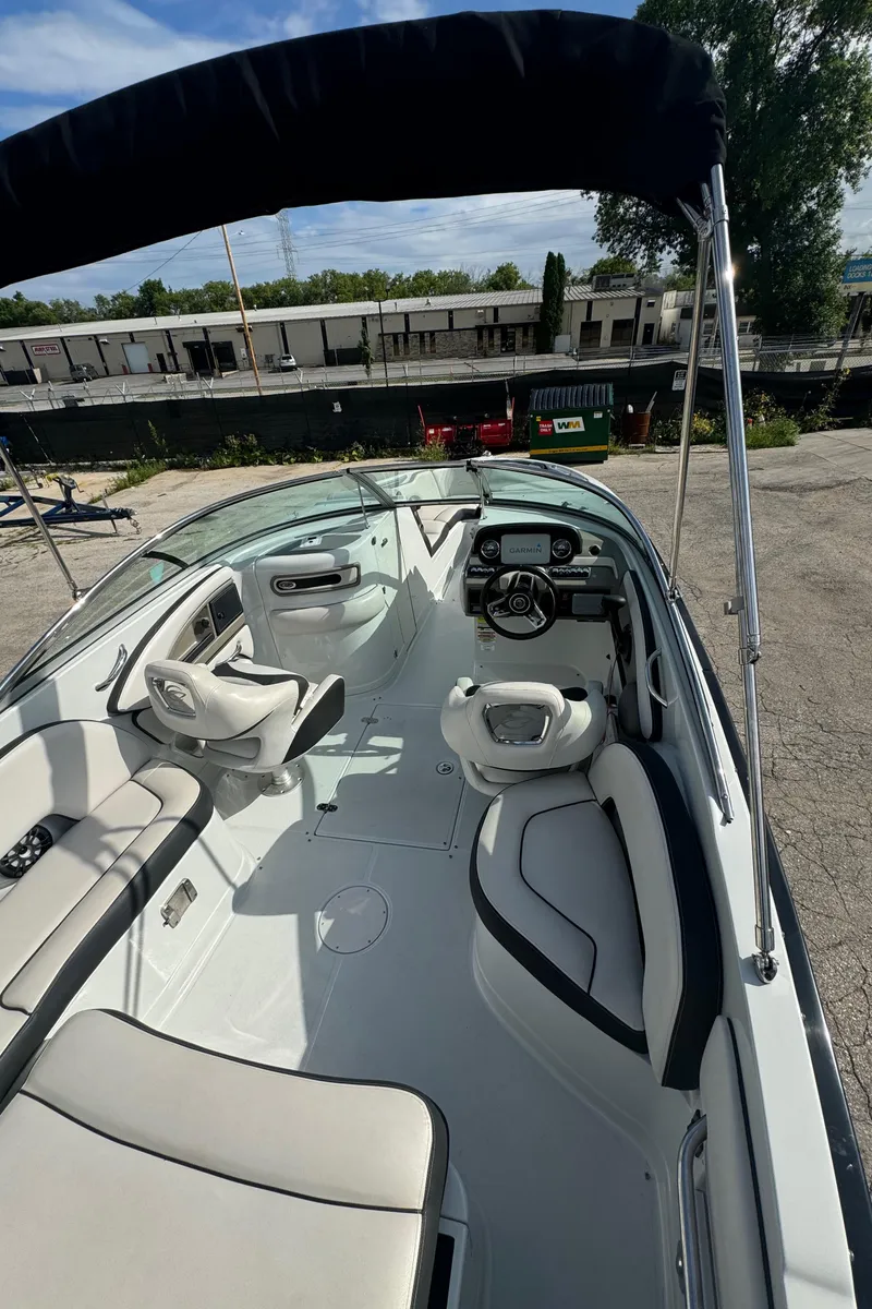 Slide: The Image of 2020 Crownline 255 SS boat interior with seating and steering wheel. - 7