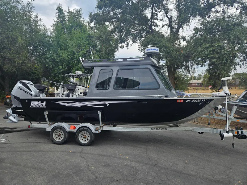 Slide: The Image of 2022 RH Boats 22 Coastal Hard Top on trailer, parked outdoors. - 1