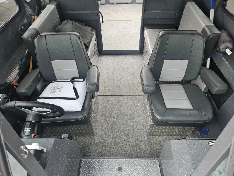 Slide: The Image of 2022 RH Boats 22 Coastal Hard Top interior with gray seating and steering wheel. - 11