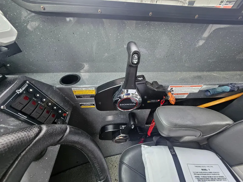 Slide: The Image of 2022 RH Boats 22 Coastal Hard Top interior controls and steering wheel. - 19