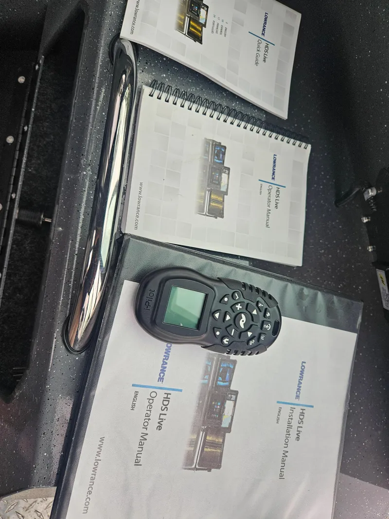 Slide: The Image of Boat manuals and remote control on RH Boats 22 Coastal Hard Top, 2022 model. - 22