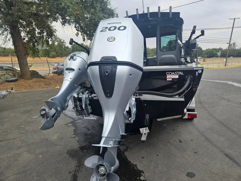 Slide: The Image of 2022 RH Boats 22 Coastal Hard Top with dual Honda 200 engines, parked outdoors. - 3