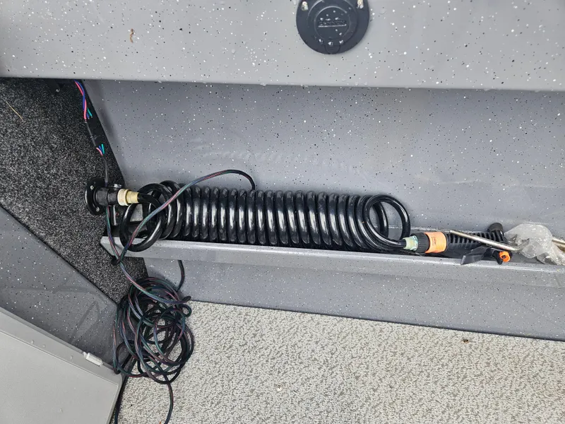 Slide: The Image of Coiled hose in 2022 RH Boats 22 Coastal Hard Top interior. - 9