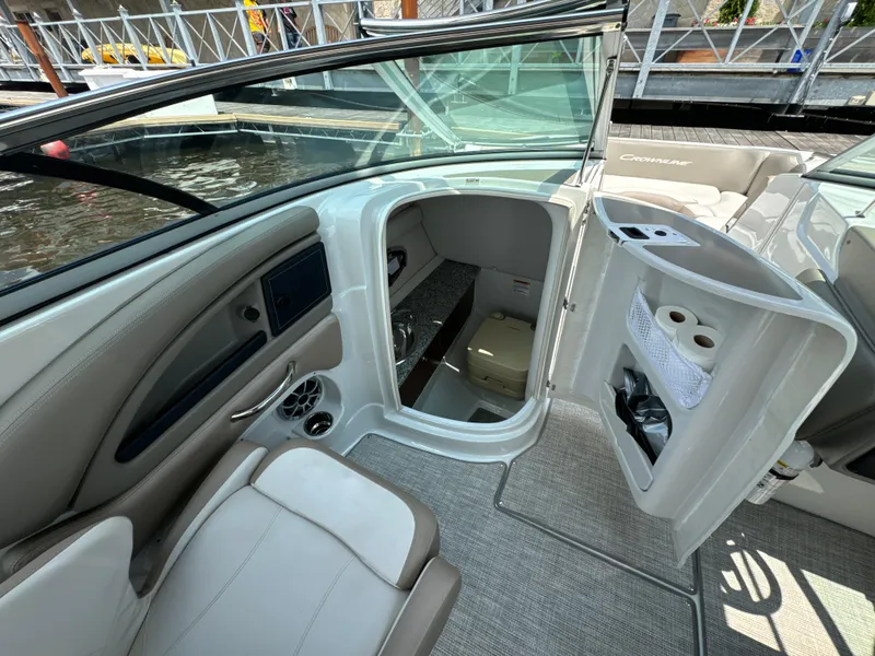 Slide: The Image of 2023 Crownline 255 XS boat interior with seating and cabin entrance. - 14