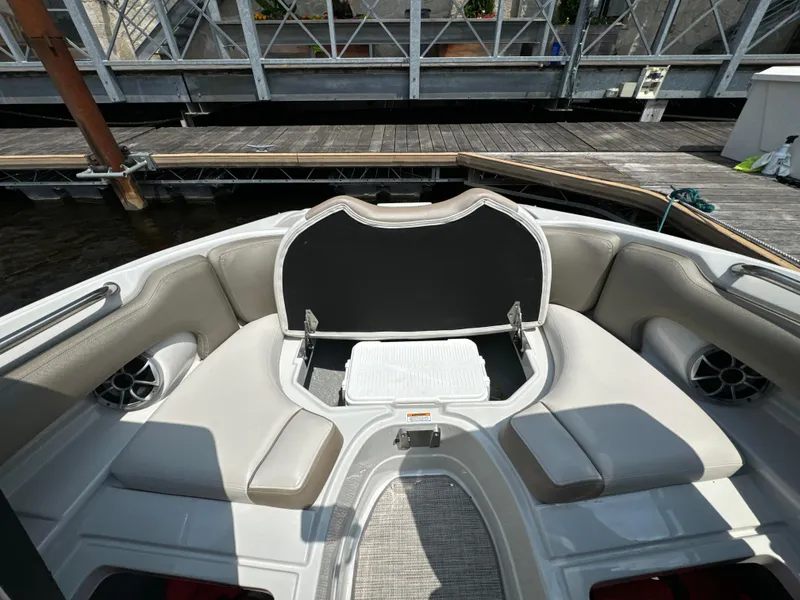 Slide: The Image of 2023 Crownline 255 XS boat interior with cushioned seating and storage. - 15