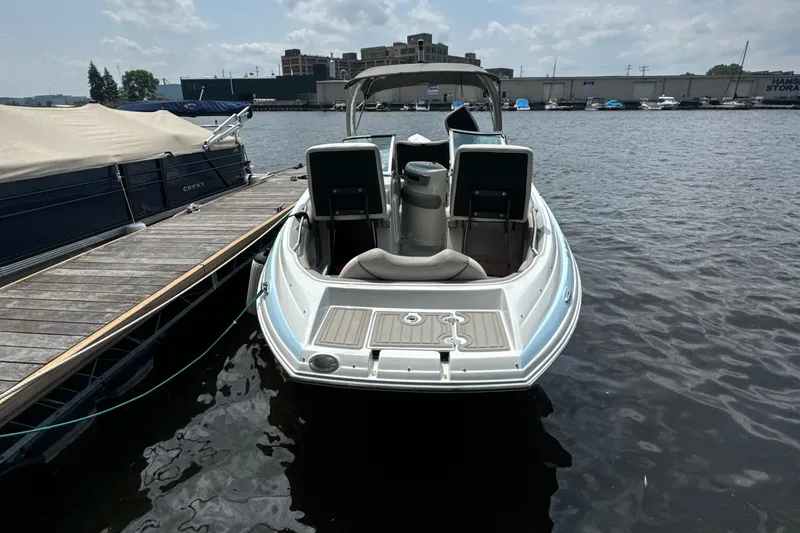 Slide: The Image of 2023 Crownline 255 XS boat docked on a sunny day. - 23