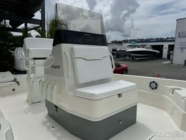 Slide: The Image of 2025 Skeeter SX230 boat console with seating, displayed outdoors. - 10