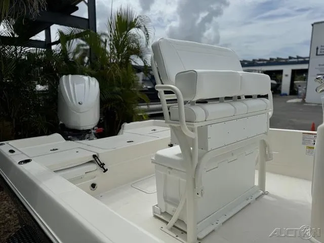 Slide: The Image of 2025 Skeeter SX230 boat with white seating and outboard motor in a marina setting. - 14