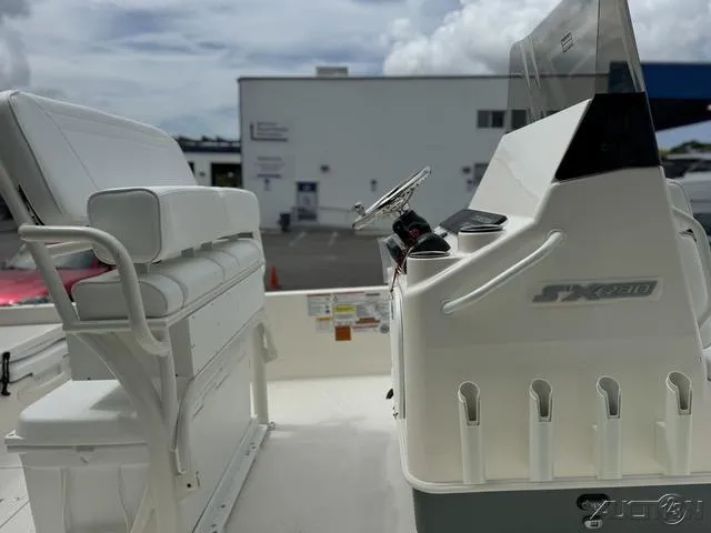 Slide: The Image of 2025 Skeeter SX230 boat interior with steering console and seating. - 15