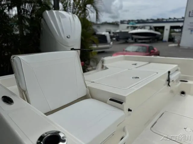 Slide: The Image of 2025 Skeeter SX230 boat interior with white seating and storage compartments. - 17