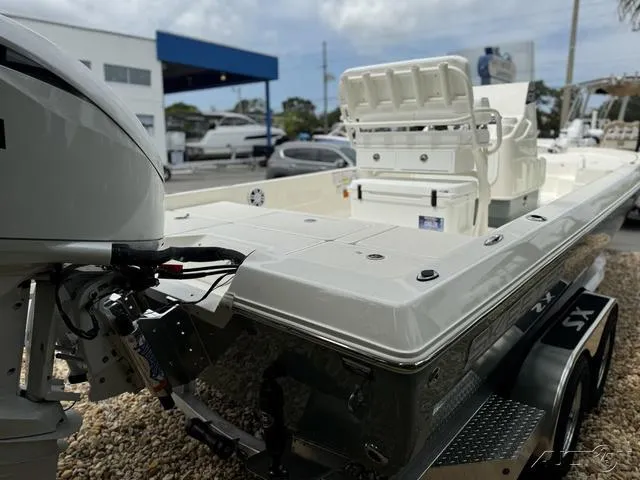 Slide: The Image of 2025 Skeeter SX230 boat with outboard motor in a dealership lot. - 19