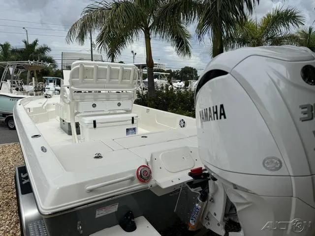 Slide: The Image of 2025 Skeeter SX230 boat with Yamaha engine, parked near palm trees. - 22