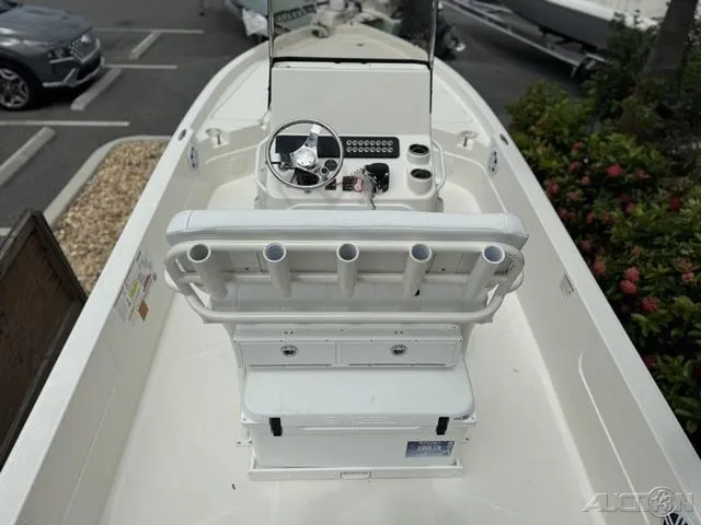 Slide: The Image of 2025 Skeeter SX230 boat interior with steering console and rod holders. - 24