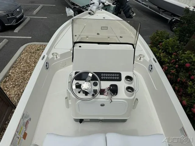 Slide: The Image of 2025 Skeeter SX230 boat interior with steering console and cup holders. - 25
