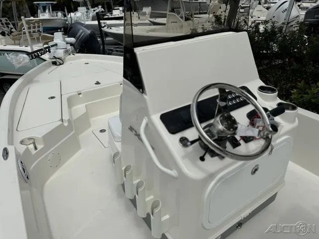 Slide: The Image of 2025 Skeeter SX230 boat interior with steering console and rod holders. - 26
