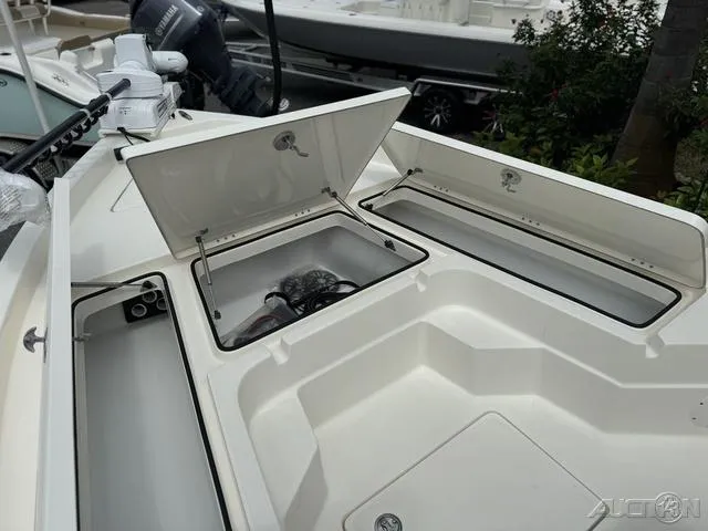 Slide: The Image of 2025 Skeeter SX230 boat storage compartments open, showcasing spacious design. - 29