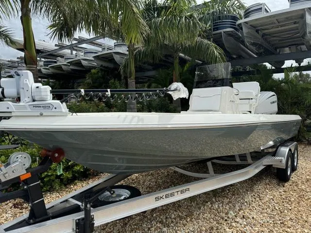 Slide: The Image of 2025 Skeeter SX230 boat on trailer, surrounded by tropical plants. - 3