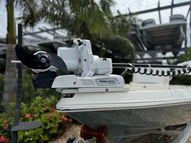 Slide: The Image of Skeeter SX230 boat with Minn Kota trolling motor, 2025 model, in a tropical setting. - 5