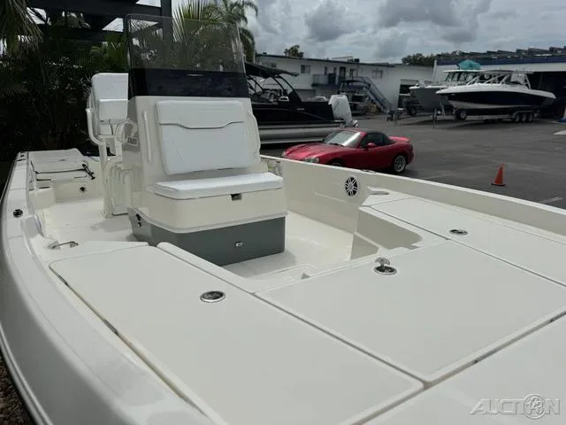 Slide: The Image of 2025 Skeeter SX230 boat in a marina, with a red car in the background. - 9