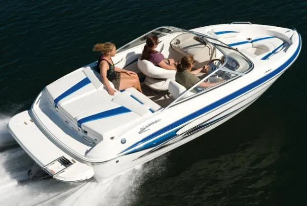 The Image of 2009 Glastron GT 185 speedboat cruising on water with passengers. - 16