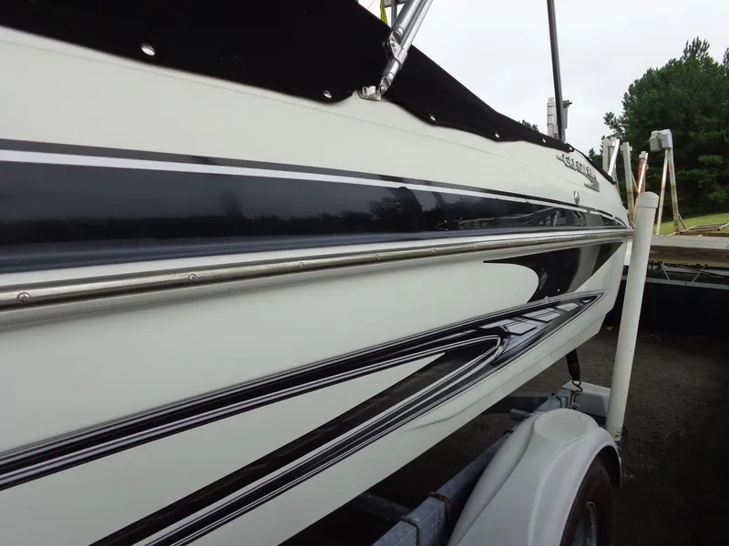 Slide: The Image of 2009 Glastron GT 185 boat on trailer, sleek black and white design. - 22