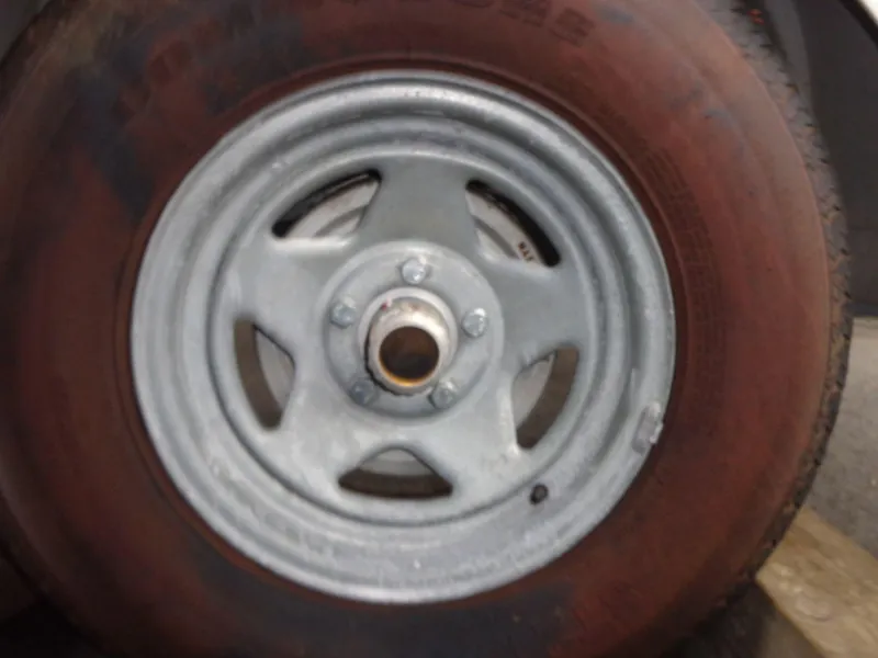 Slide: The Image of Close-up of a 2009 Glastron GT 185 trailer wheel and tire. - 24
