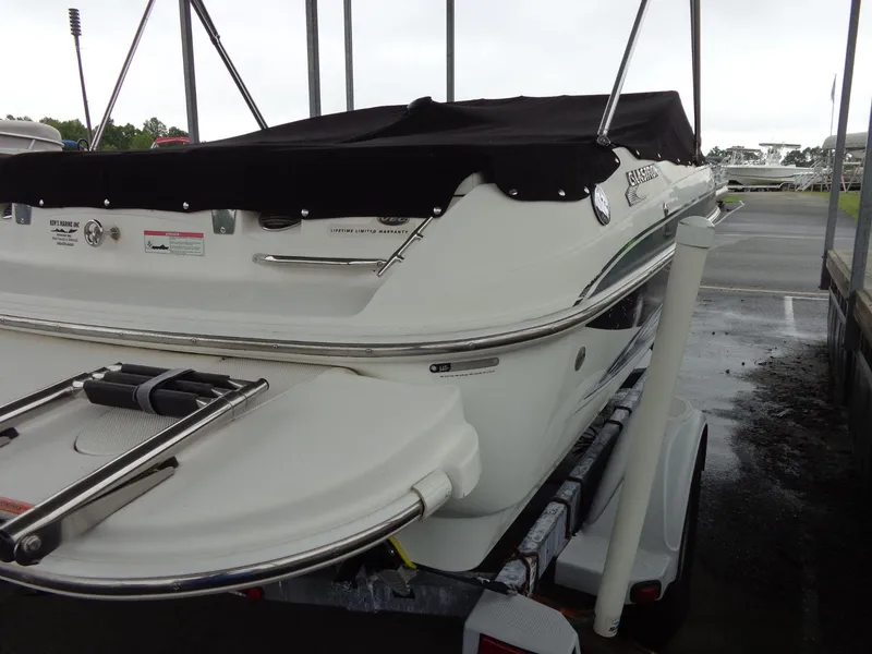 Slide: The Image of 2009 Glastron GT 185 boat with black cover on trailer. - 27