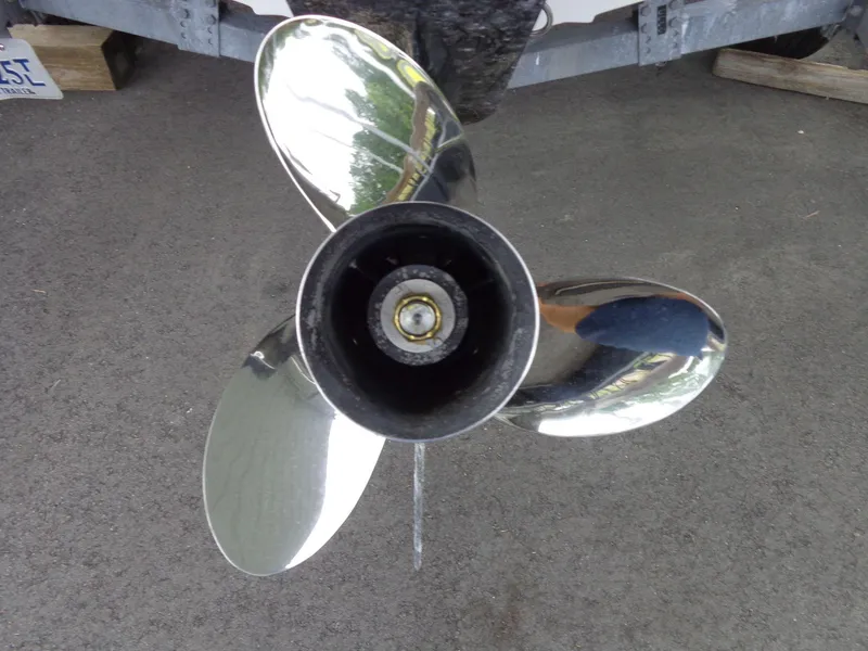 Slide: The Image of Close-up of a 2009 Glastron GT 185 boat propeller on pavement. - 30