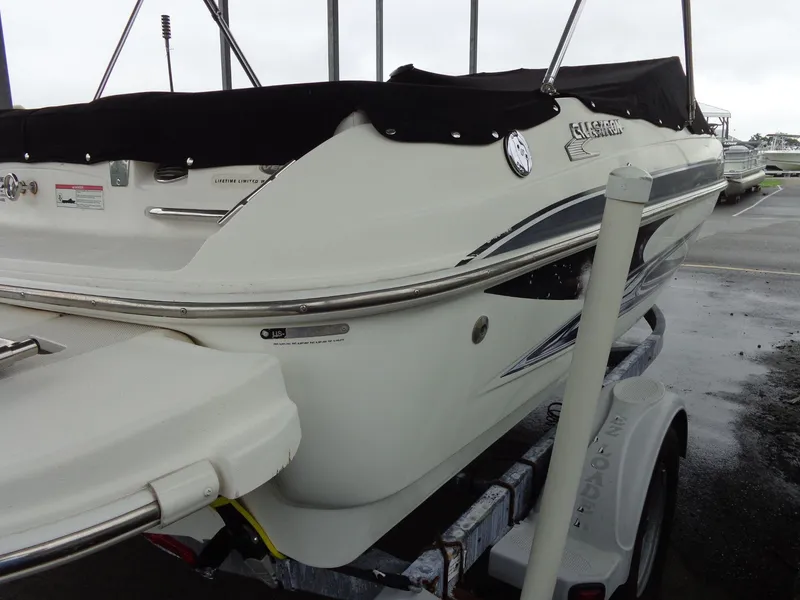 Slide: The Image of 2009 Glastron GT 185 boat on trailer, rear view, with black cover. - 31