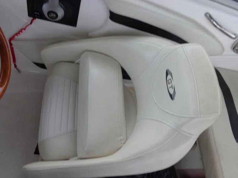 Slide: The Image of White leather seat in a 2009 Glastron GT 185 boat interior. - 37