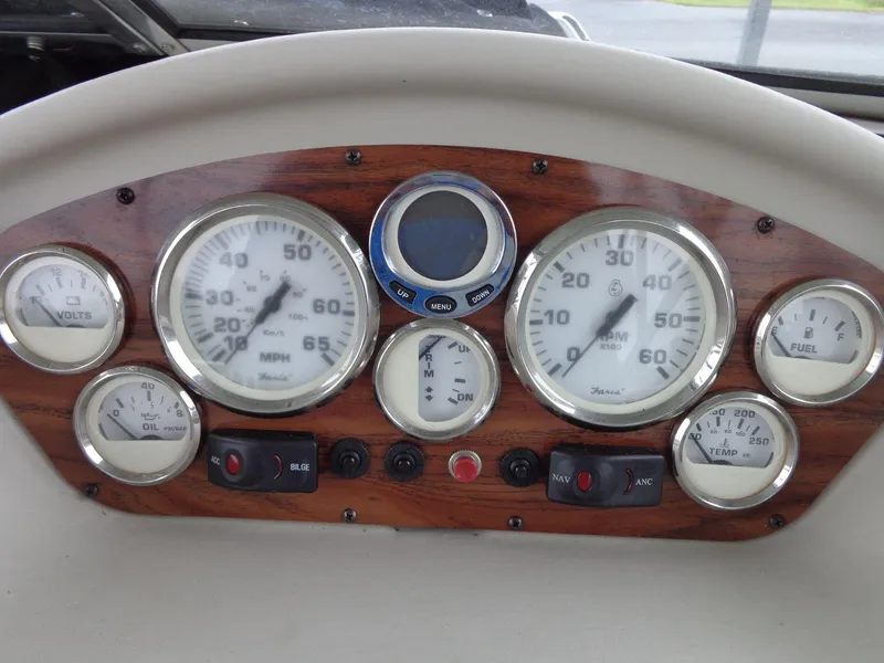 Slide: The Image of Dashboard of a 2009 Glastron GT 185 boat with gauges and controls. - 39